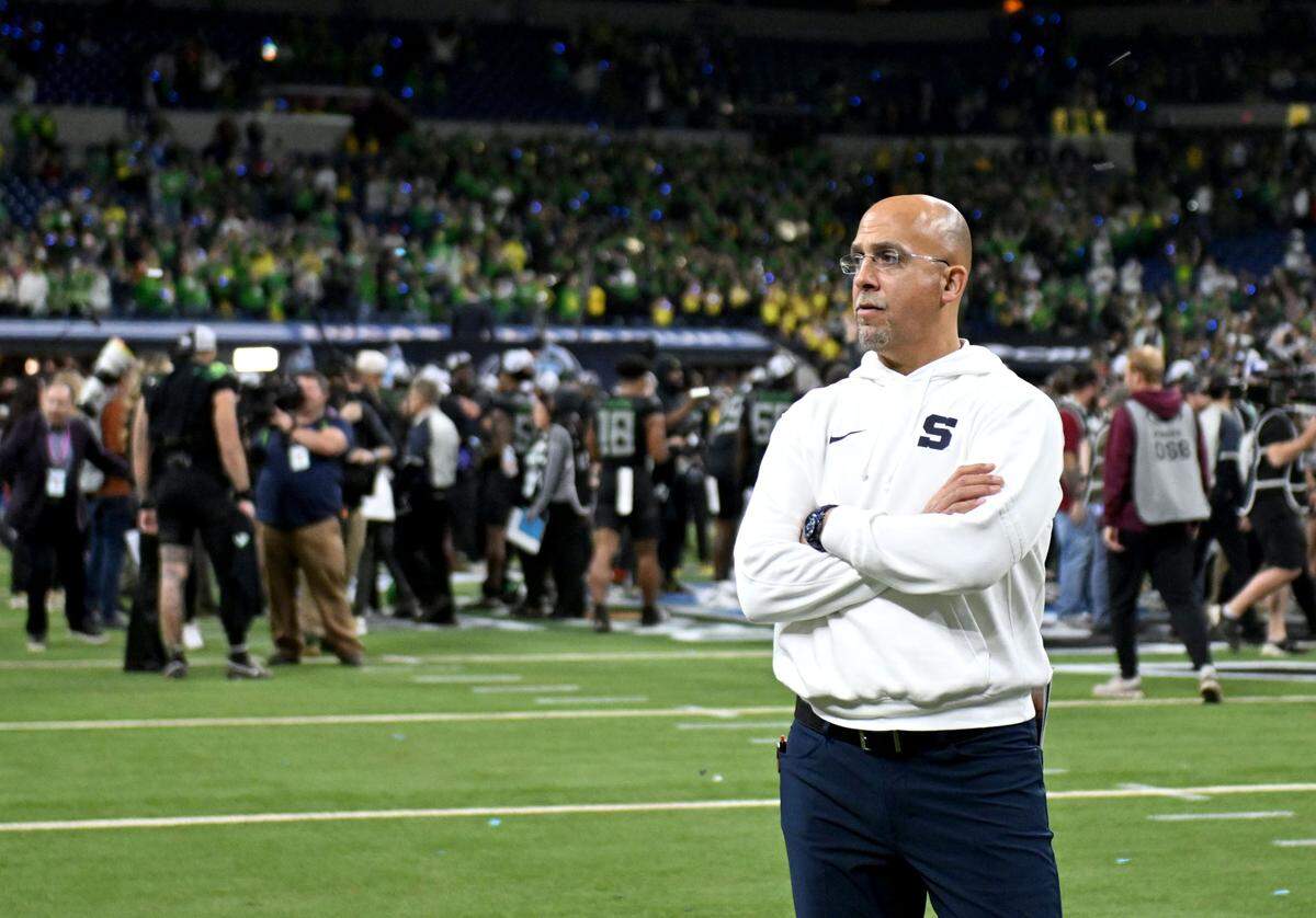 Penn State football coach James Franklin watches his players as they walk off the field in disappointment after falling to Oregon in the Big Ten Championship game at Lucas Oil Stadium on Saturday, Dec. 7, 2024.  