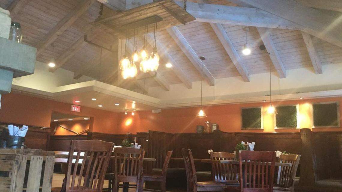The Field Burger and Tap features local, repurposed decor like an old barn door that hangs from its ceiling. The restaurant will host a grand opening and open house Wednesday. 
