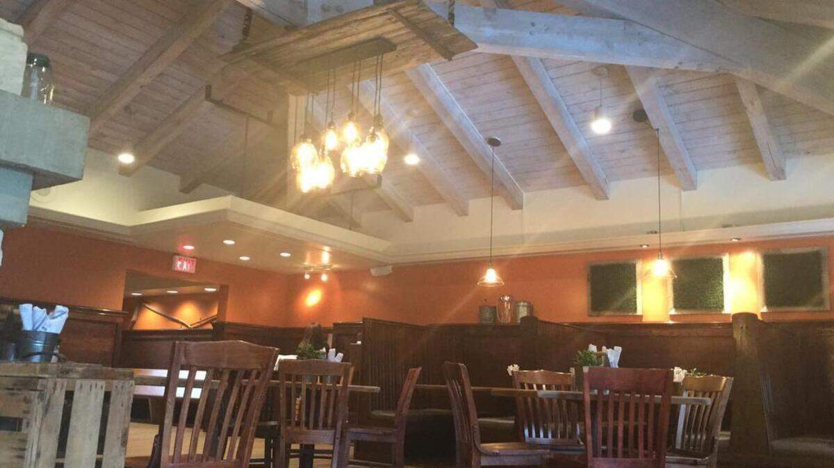 The Field Burger and Tap features local, repurposed decor like an old barn door that hangs from its ceiling. The restaurant will host a grand opening and open house Wednesday. 
