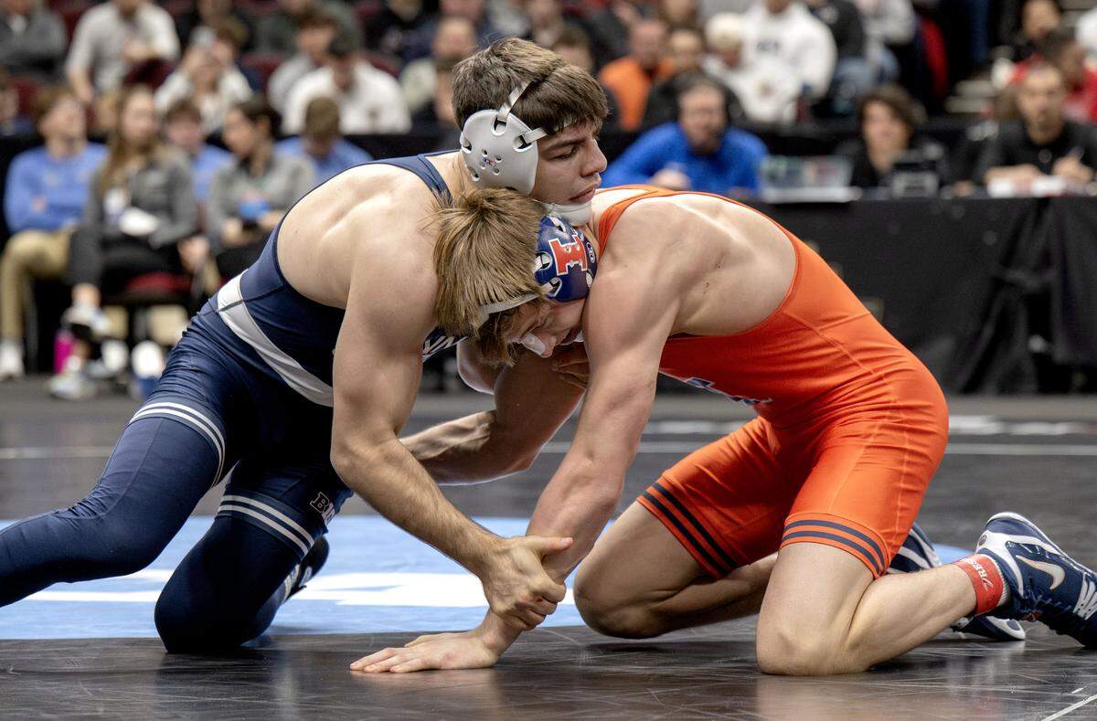 Penn State's PJ Duke wrestles Illinois' Kannon Webster in a 157-pound consolation semifinal bout at the NCAA Wrestling Championships on Saturday, March 21, 2026.  