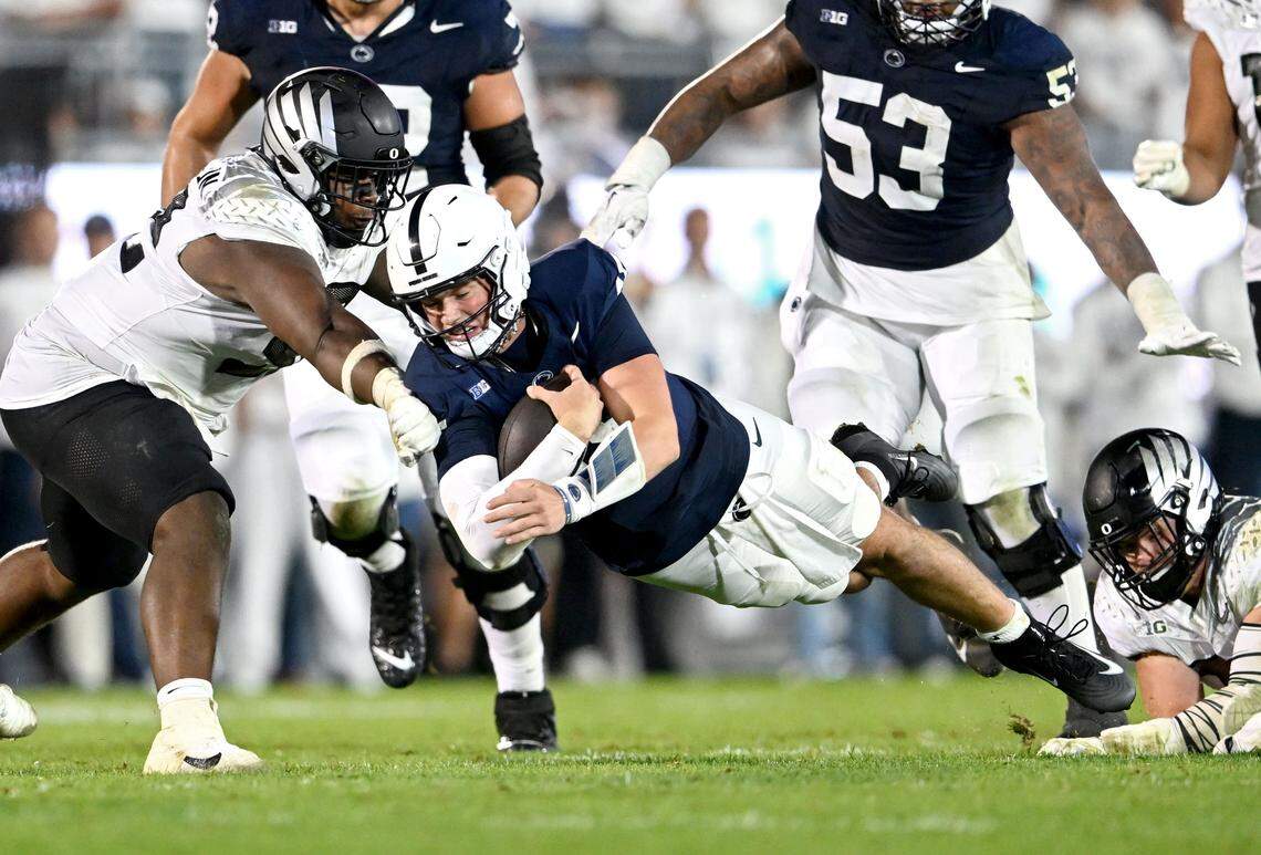 Penn State quarterback Drew Allar dives past Oregon defenders for a first town during the game on Saturday, Sept. 27, 2025.
