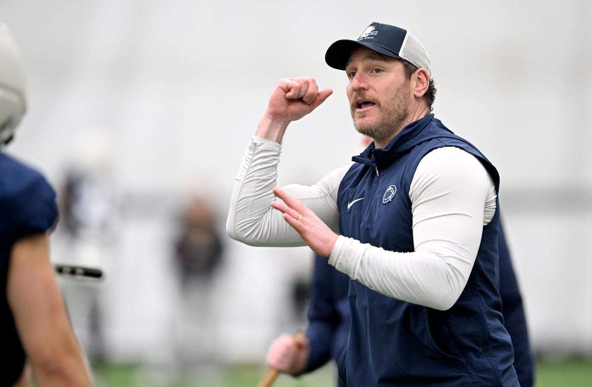 Penn State linebackers coach Dan Connor goes over a technique with his players during spring football practice on Tuesday, April 1, 2025.