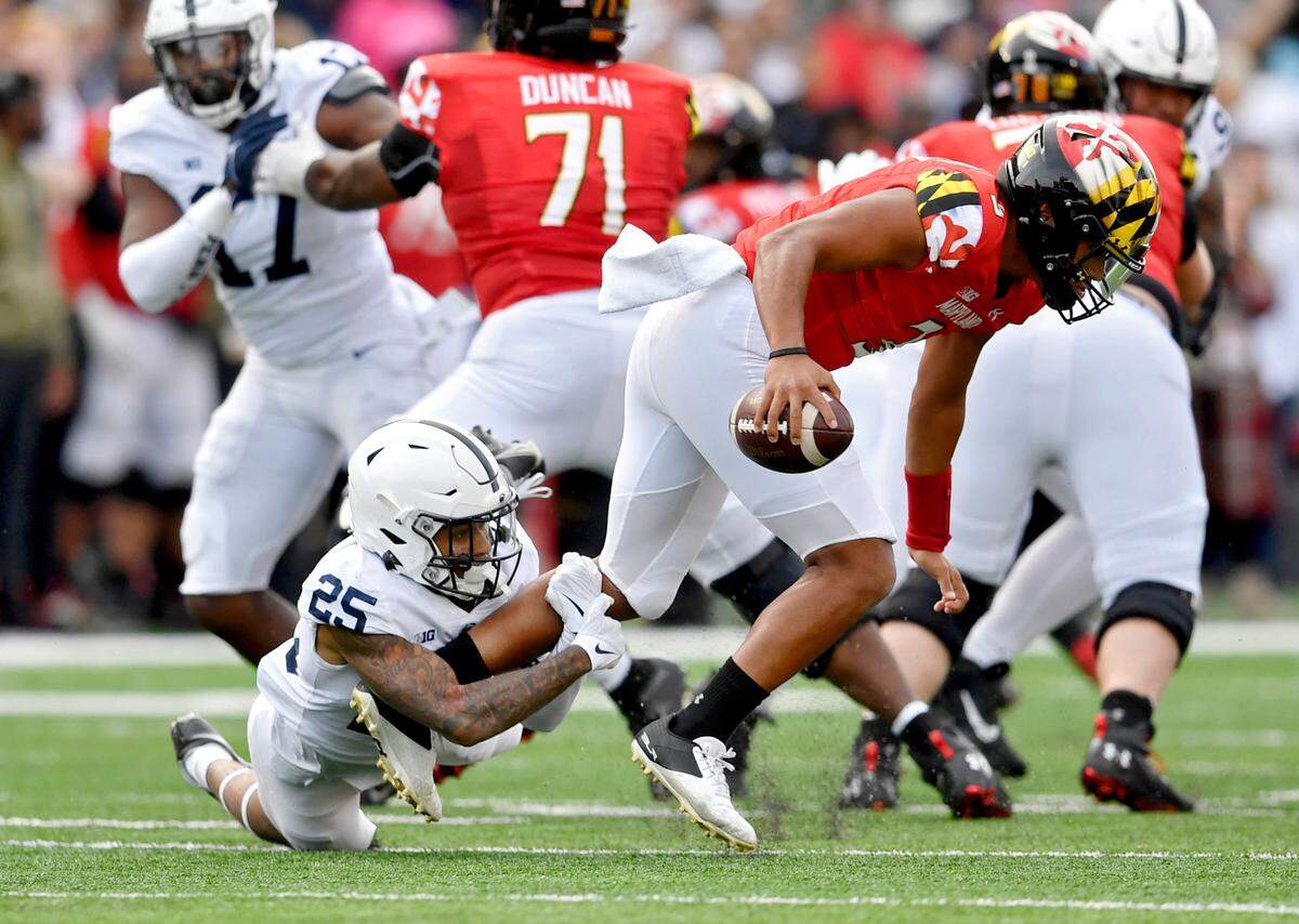 Penn State cornerback Daequan Hardy trips up Maylrand quarterback Taulia Tagovailoa during the game on Saturday, Nov. 6, 2021.
