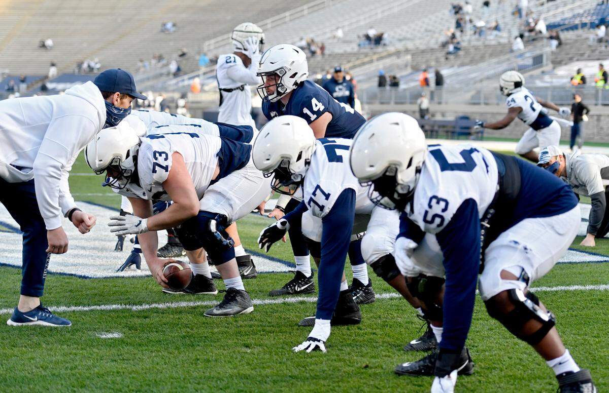 Quarterback Sean Clifford gets ready to take the snap from Mike Miranda during Penn State football practice on Friday, April 23, 2021 at Beaver Stadium.
