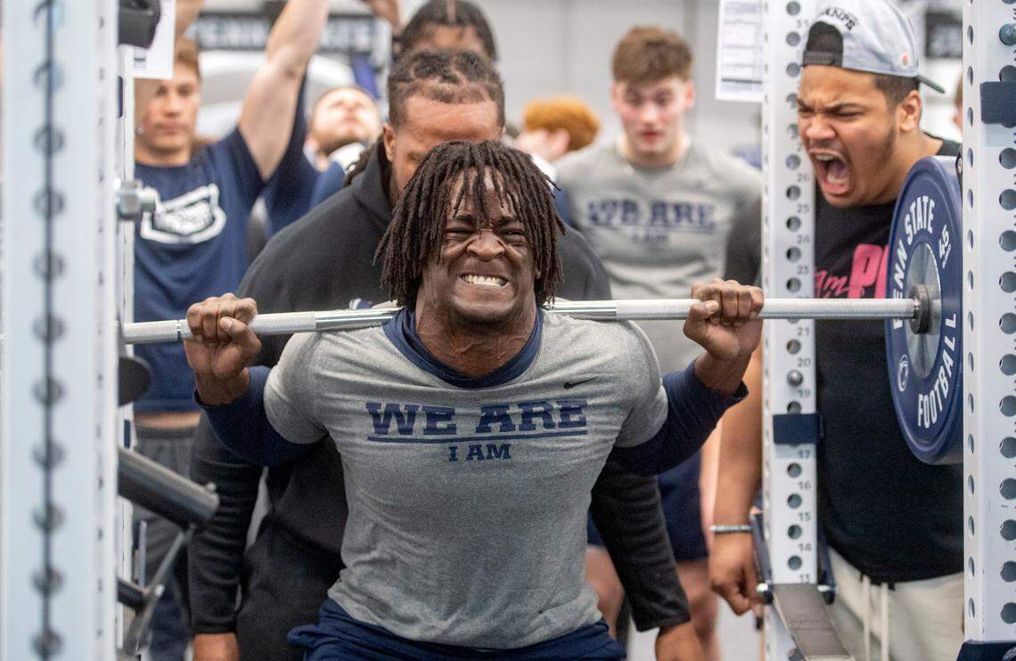 Teammates cheer on Penn State tight end Khalil Dinkins as he squats during a max-out lifting session on Thursday, March 2, 2023.