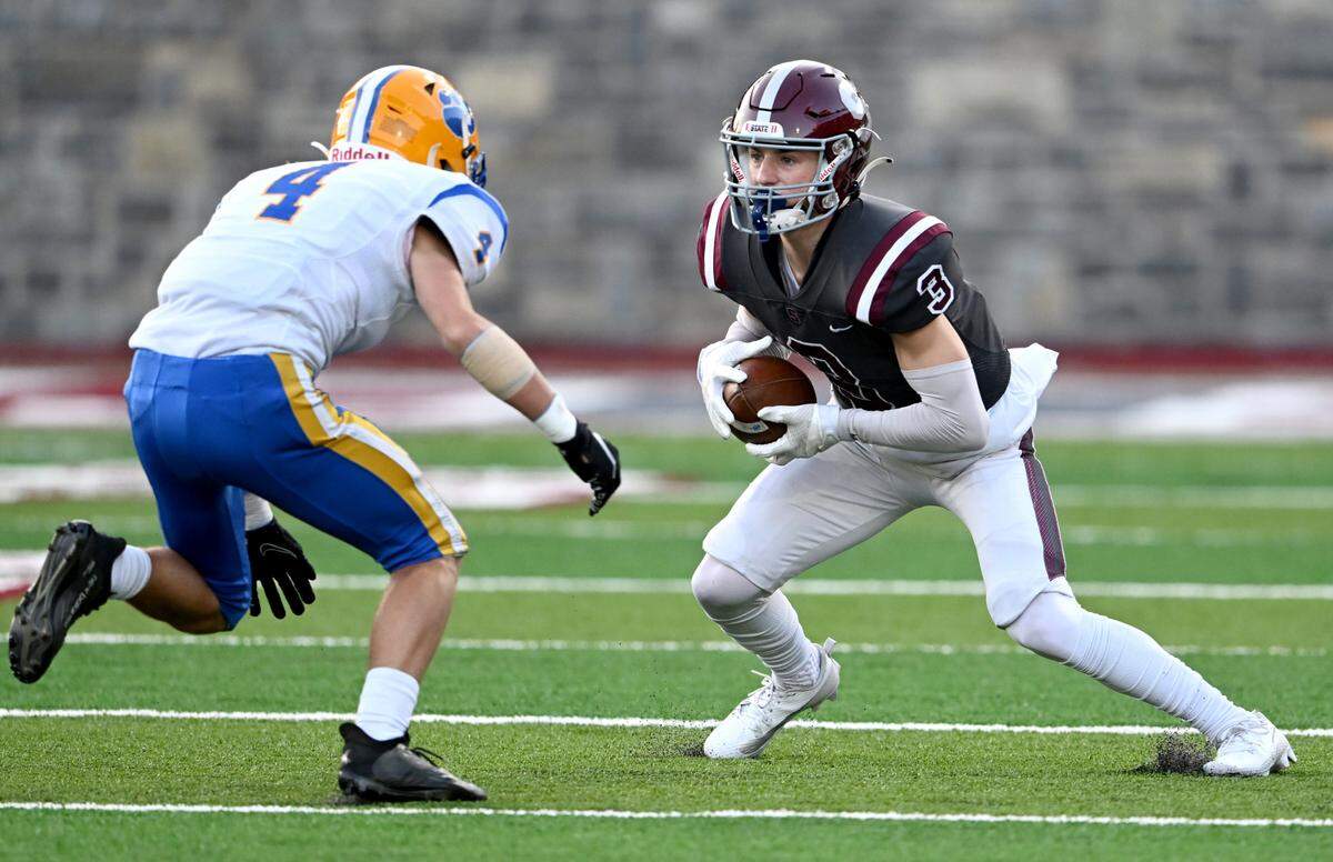 State College’s Ty Salazer cuts down the field with the ball from Downingtown East’s Paxon Warnock during the game on Friday, Sept. 1, 2023.