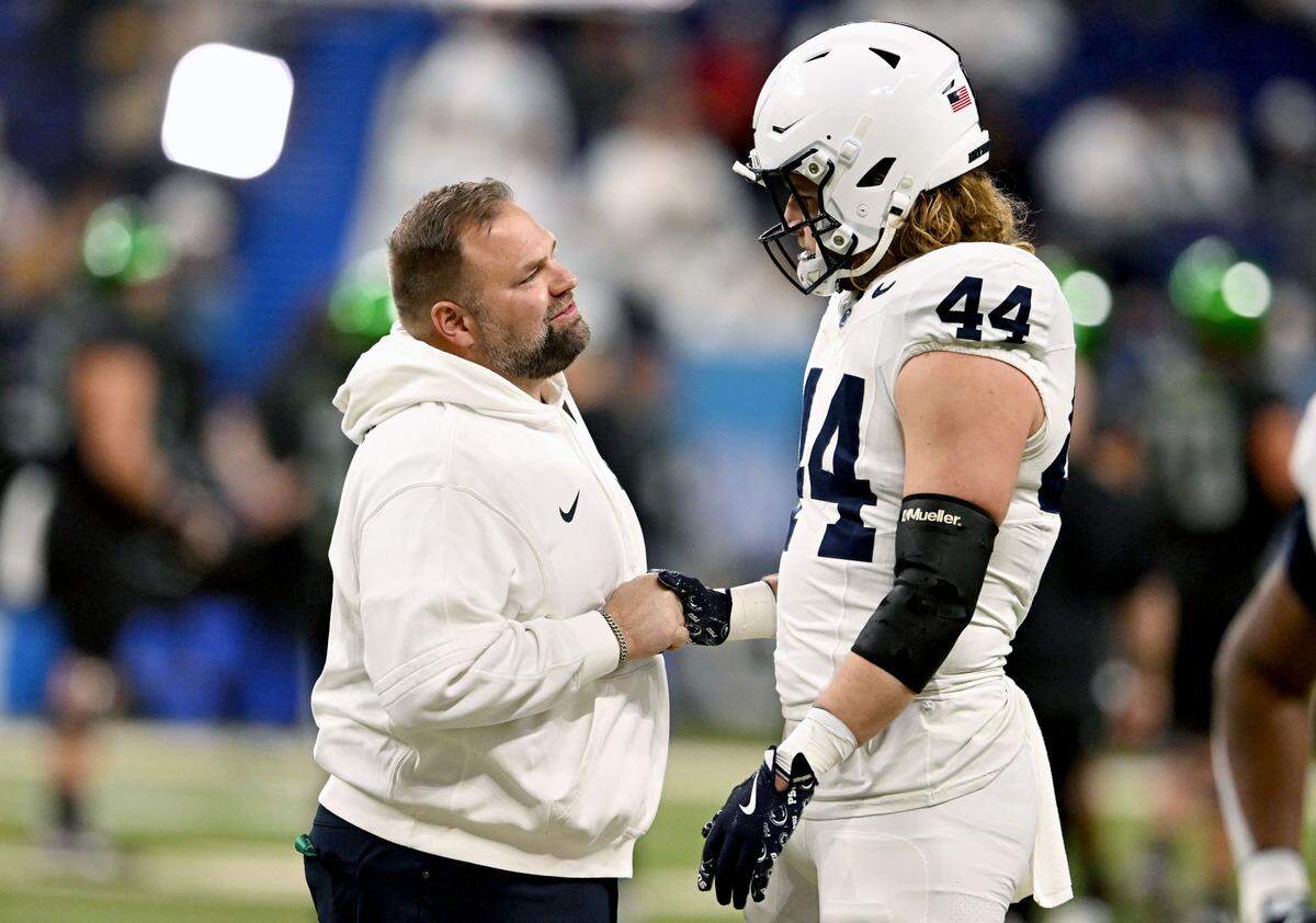 Penn State offensive coordinator Andy Kotelnicki talks to tight end Tyler Warren before the Big Ten Championship game at Lucas Oil Stadium on Saturday, Dec. 7, 2024.