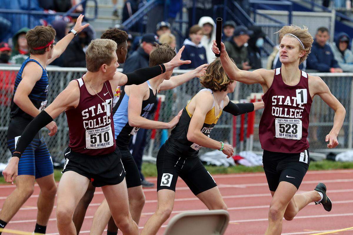 State College’s Matt Staniar, right, hands off the baton to teammate Brady Bigger, left, in the boys Class 3A 4x800 meter relay finals during the PIAA State Track and Field Championships held Saturday, May 29, 2021, at Seth Grove Stadium on the Shippensburg University campus in Shippensburg, PA.