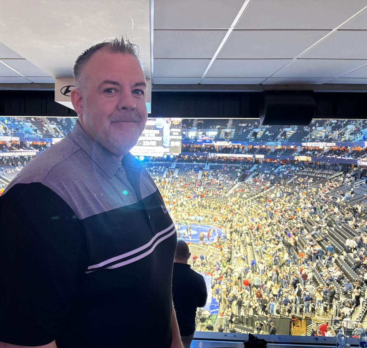 Philipsburg-Osceola wrestling coach Justin Fye, who serves as the district’s elementary principal, poses in his suite at the 2025 NCAA Wrestling Championships on Friday at the Wells Fargo Center in Philadelphia.