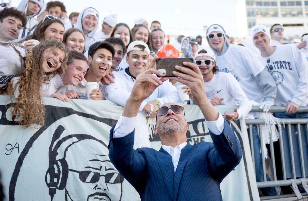Penn State football coach James Franklin takes a selfie with a group in the student section as he arrives at Beaver Stadium for the game against Ohio State on Saturday, Nov. 2, 2024.