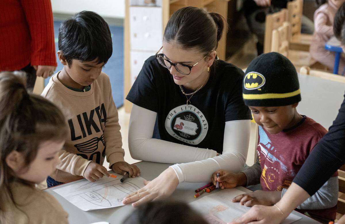 Heidi Egerer, a member of the State College Area High School Key Club, helps students in the Head Start class at Ferguson Elementary make listening ears after reading a book to them on Monday, Nov. 17, 2025. Each child in the class received a free book thanks to the Pennsylvania Key Club and The LiTEArary Society.