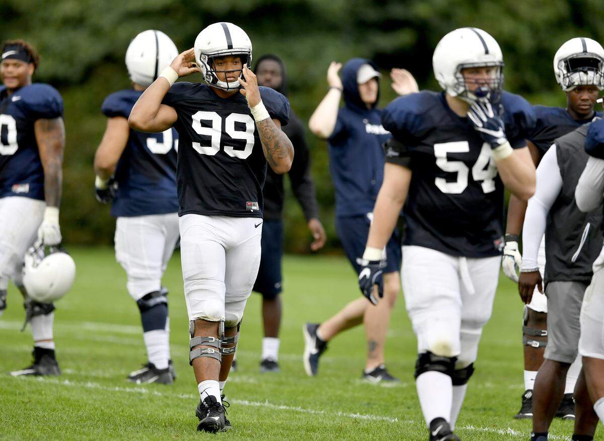 Penn State defensive end Yetur Gross-Matos snaps on his helmet during practice on Tuesday, August 21, 2018.   