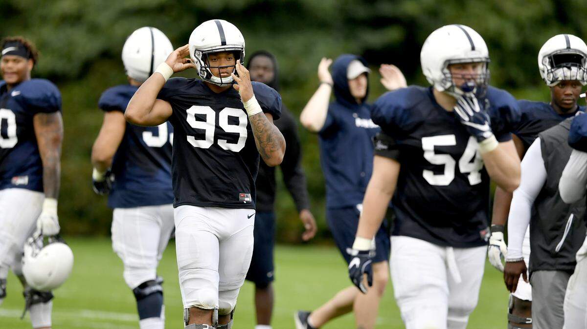 Penn State defensive end Yetur Gross-Matos snaps on his helmet during practice on Tuesday, August 21, 2018.   