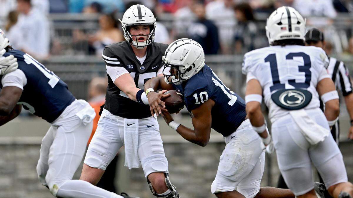 Quarterback Drew Allar hands off to running back Nick Singleton during the Penn State Blue-White game on Saturday, April 15, 2023.