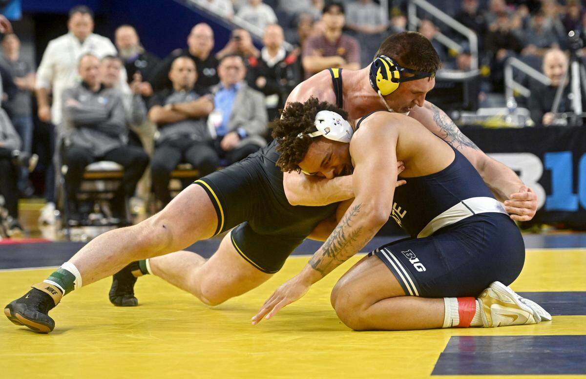 Michigan’s Mason Parris and Penn State’s Greg Kerkvliet face off in the 285 lb championship bout of the Big Ten wrestling championships at the Crisler Center on Sunday, March 5, 2023.