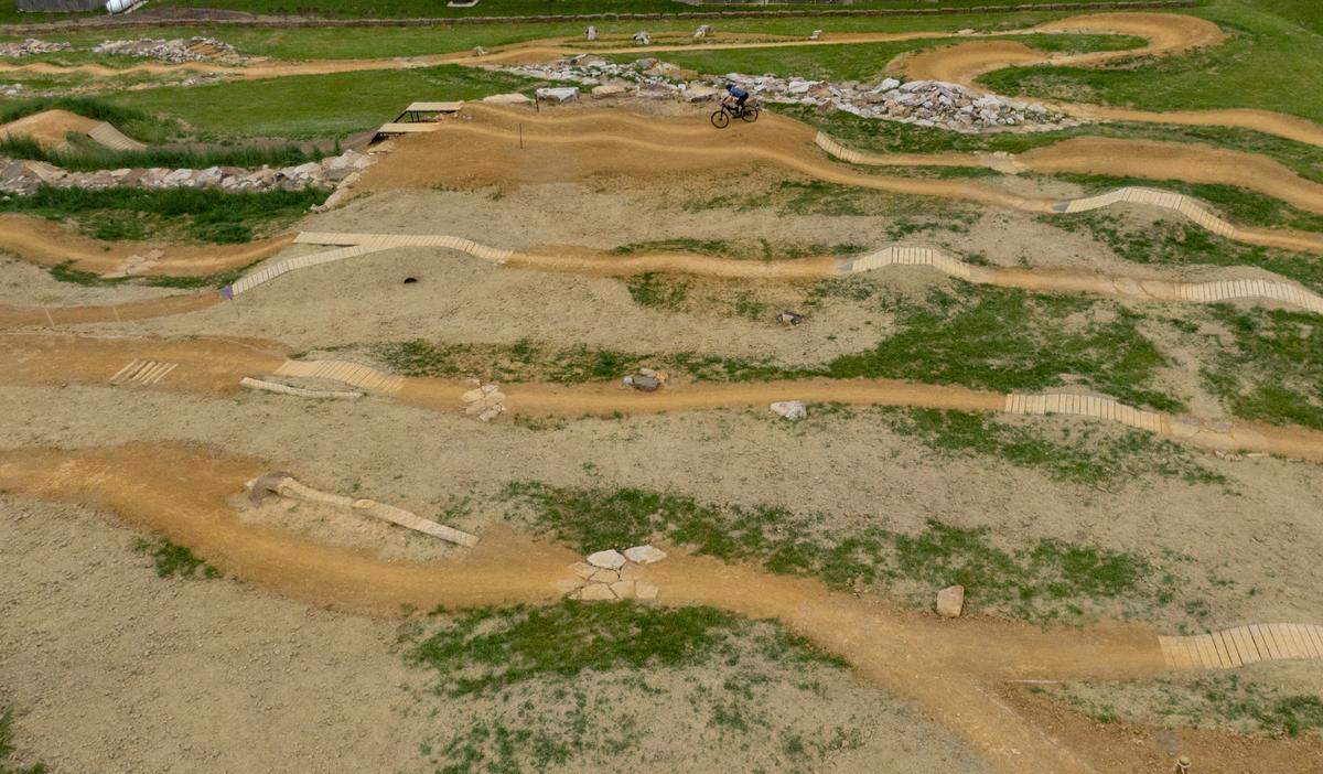 Seth Maurer bikes at the Harvest Fields community trails new skills park on Monday, May 22, 2023.
