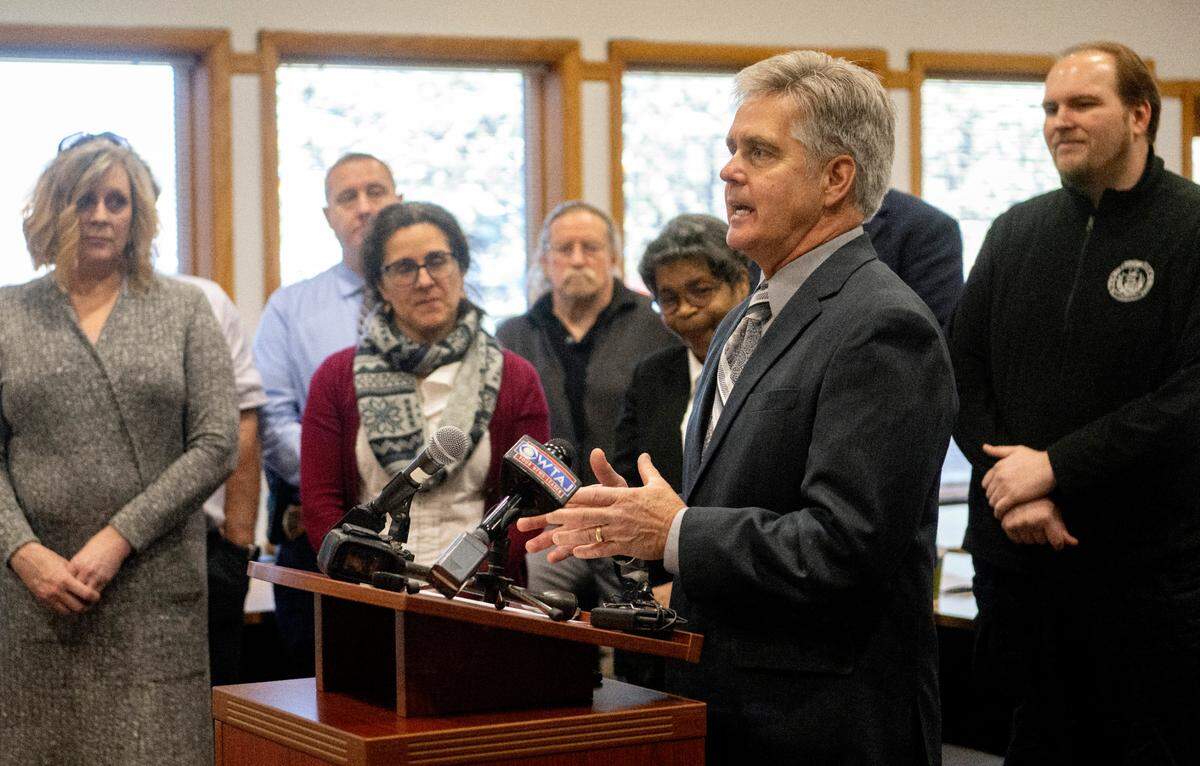 Surrounded by residents of the Georgetown Park Community and members of the Patton Township board of supervisors, Rep. Scott Conklin announces a state grant Monday to help the families whose homes were damaged by the large sinkhole on Amblewood Way in December.