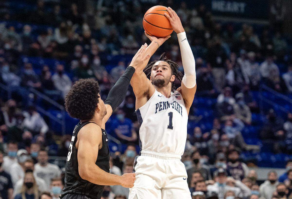 Penn State’s Seth Lundy shoots for a three pointer over a Michigan State defender to put the Nittany Lion in the lead with less than two minutes to play in the game on Tuesday, Feb. 15, 2022.