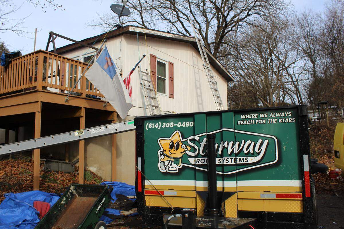 Starway Roof Systems equipment is pictured outside of U.S. Army veteran Thomas Sharpe’s home, which underwent a free roof replacement Monday.