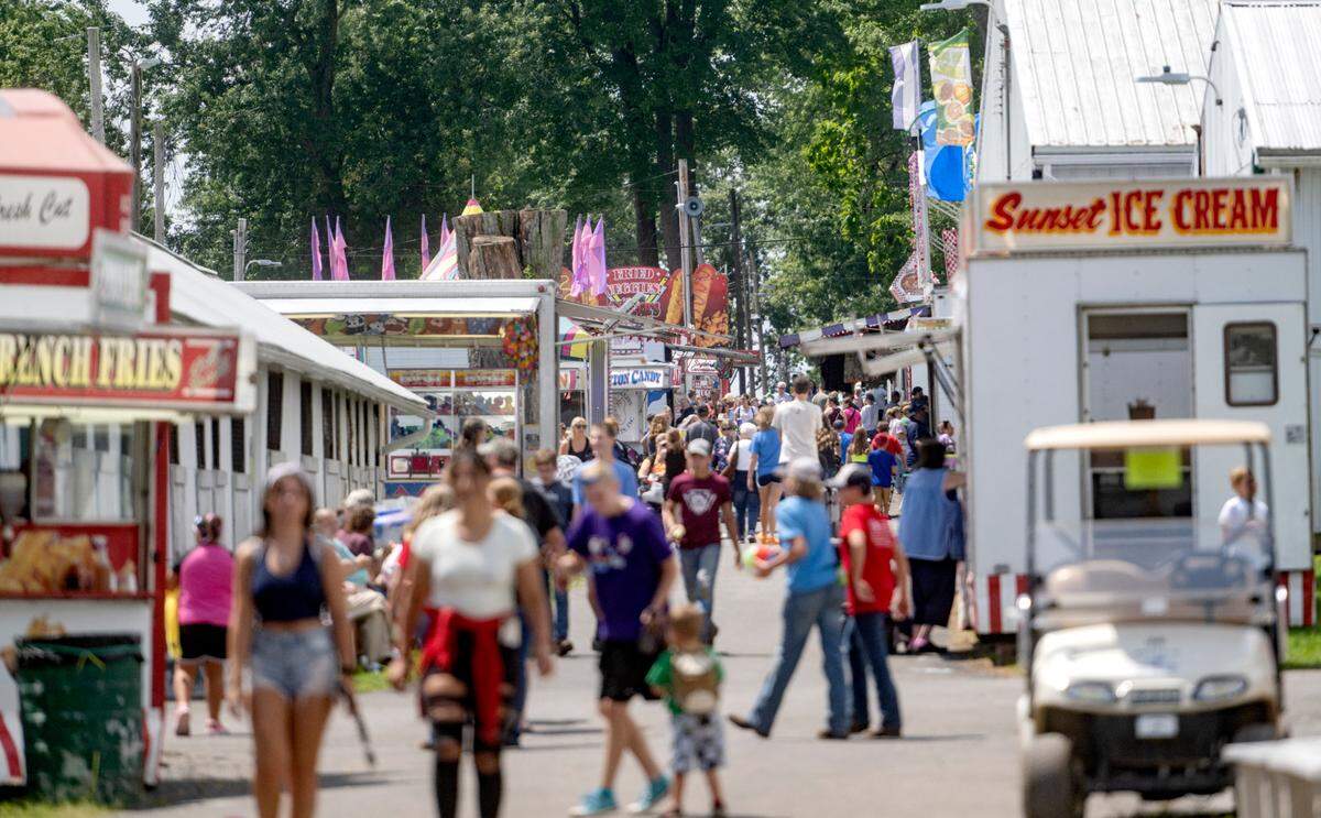 Visitors walk along the food stands at the Centre County Grange Encampment and Fair on Friday, Aug. 18, 2023.  a