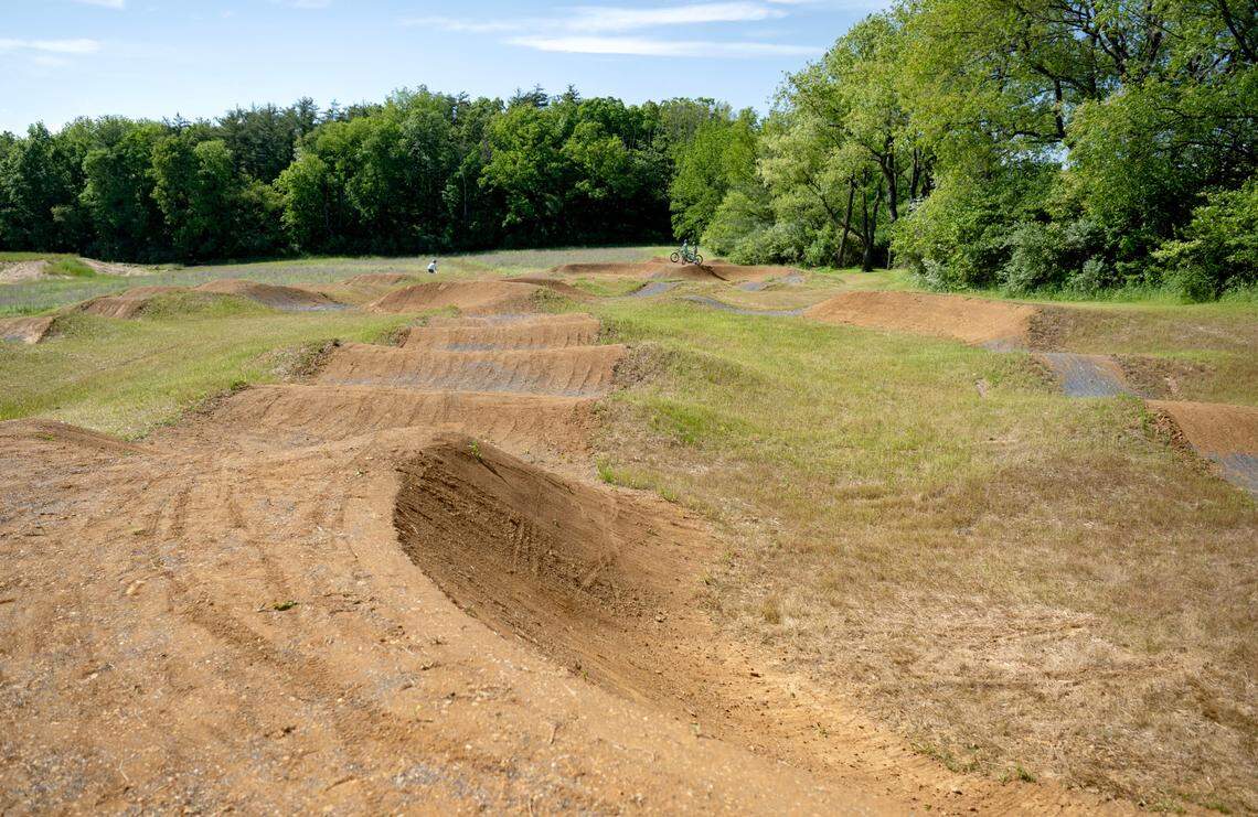 Bikers try out the new dirt pump track at Bernel Road Park on Tuesday, May 21, 2024.