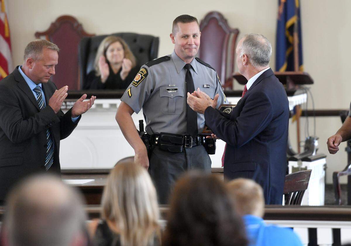 State police trooper Jeff Ebeck was awarded with the 2018 Centre County Law Enforcement Officer of the Year award on Tuesday at the Centre County Courthouse. State College police officer John W. Aston also received an award.