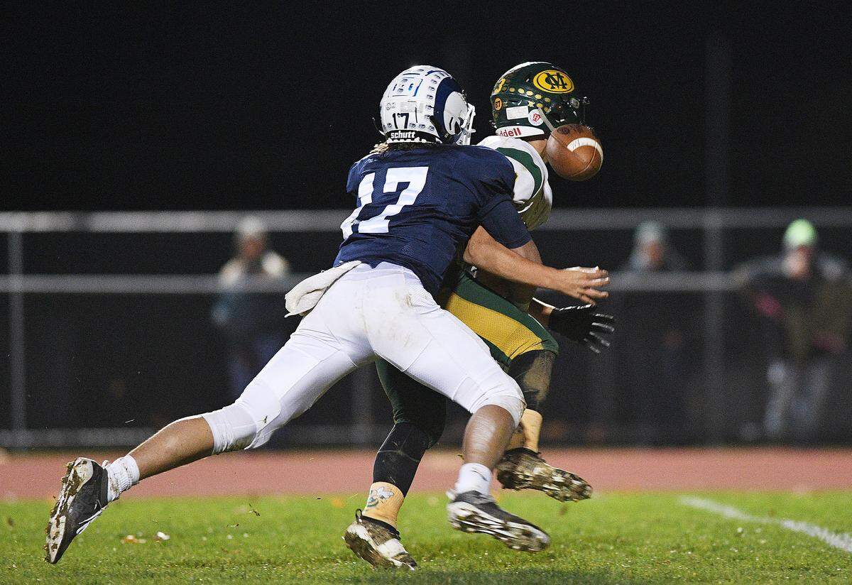 Penns Valley’s Aidan Brinker (17) strips Marion Center quarterback Ty Ryen (3) of the ball during Saturday night’s PIAA District  6 football playoffs at Penns Valley.  (For the CDT/Steve Manuel)