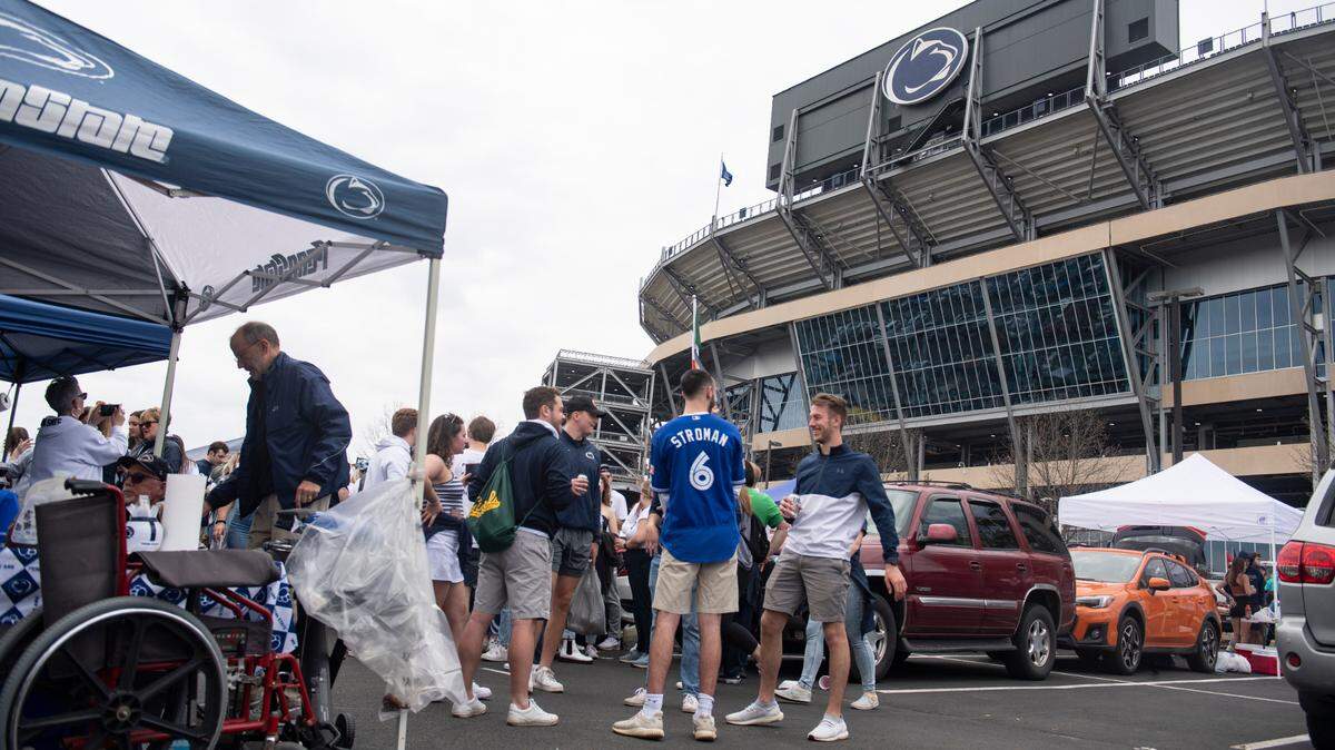 Fans gather to tailgate outside of Beaver Stadium before Penn State football’s Blue-White game on Saturday.