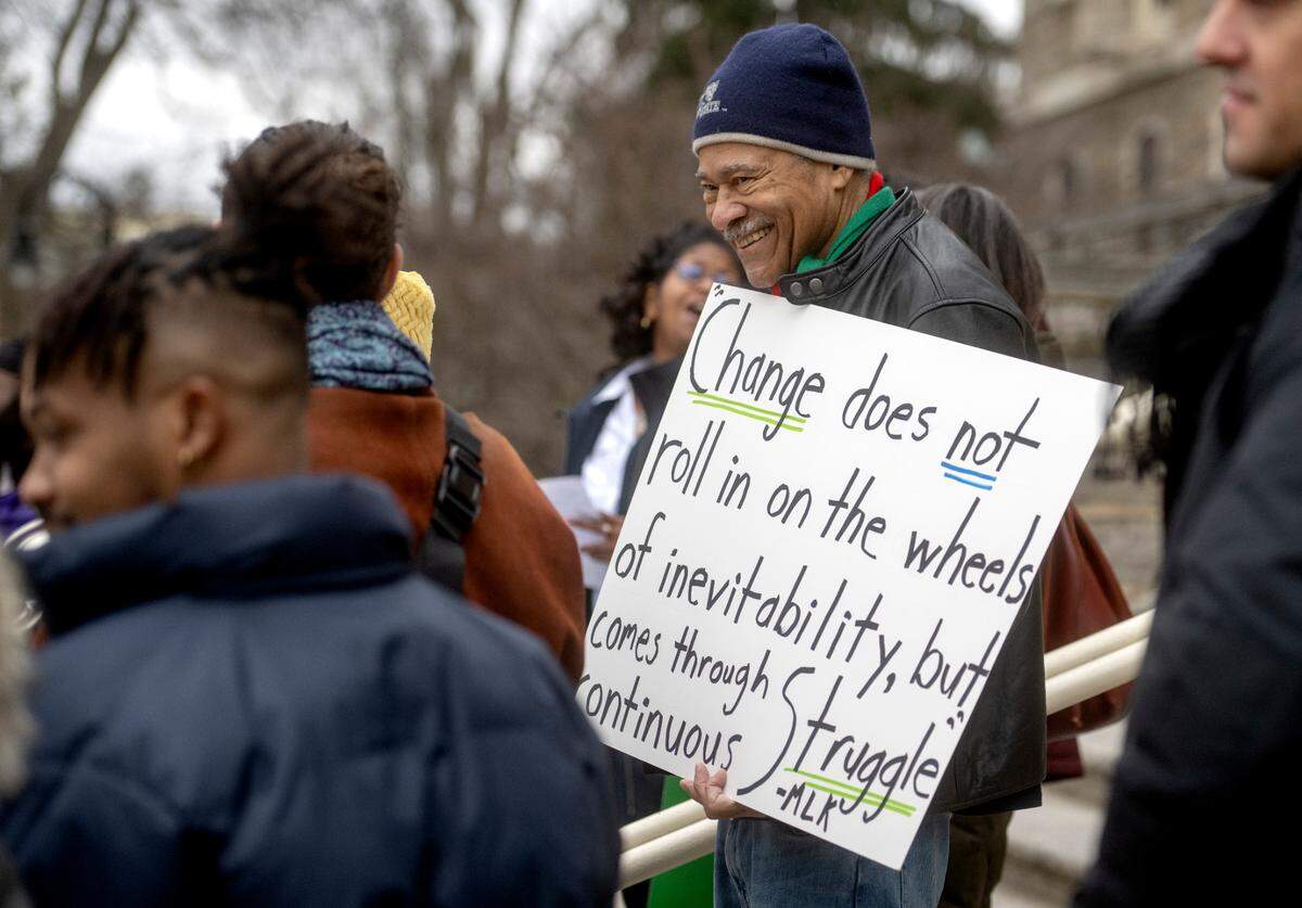 Charles Dumas laughs as he and fellow marchers chant during a “March for Peace” on Wednesday.