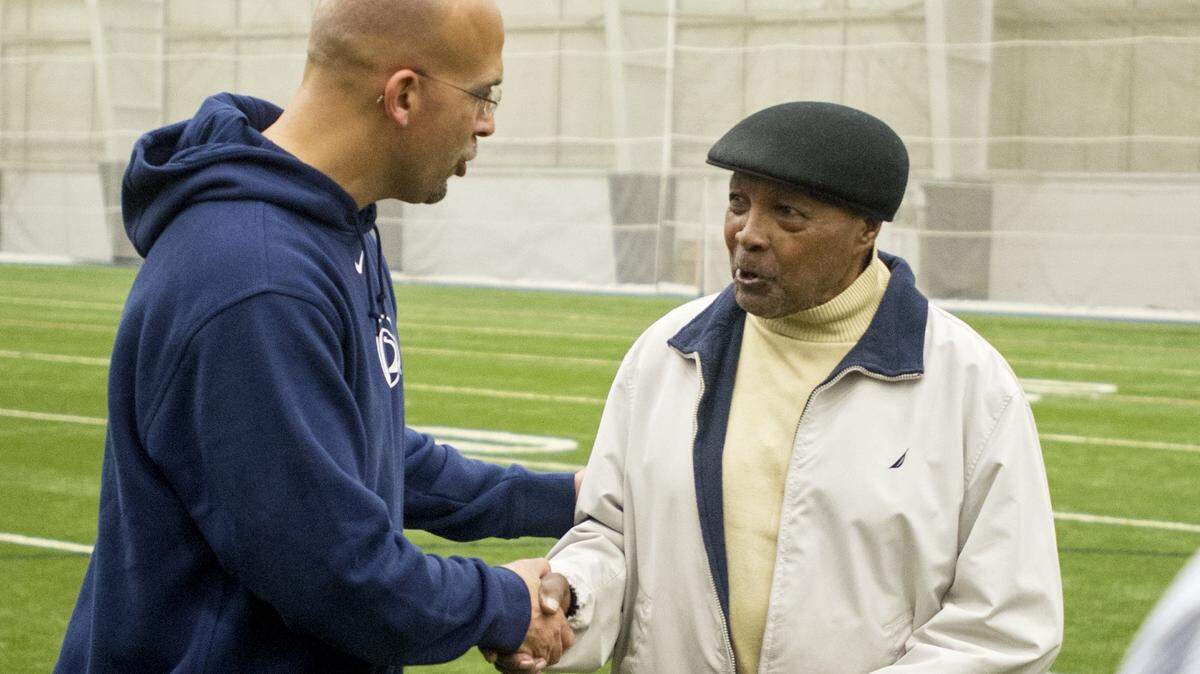 Penn State legend Wally Triplett jokes with Penn State football coach James Franklin after practice on Wednesday, November 11, 2015 in Holuba Hall.