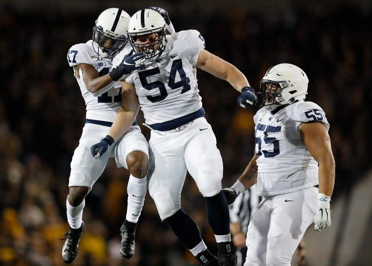Penn State defensive tackle Robert Windsor, center, celebrates a sack with safety Garrett Taylor, left, and defensive tackle Antonio Shelton, right, during the second half of an NCAA college football game against Iowa, Saturday, Oct. 12, 2019, in Iowa City, Iowa. (AP Photo/Matthew Putney)