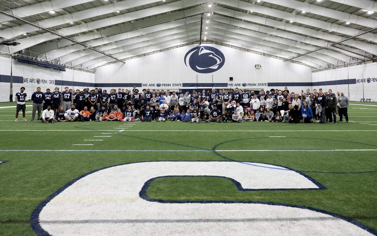 Penn State football players and Four Diamonds families gather for a photo during the Thon Explorers event at Holuba Hall on Saturday, Feb. 21, 2026.  