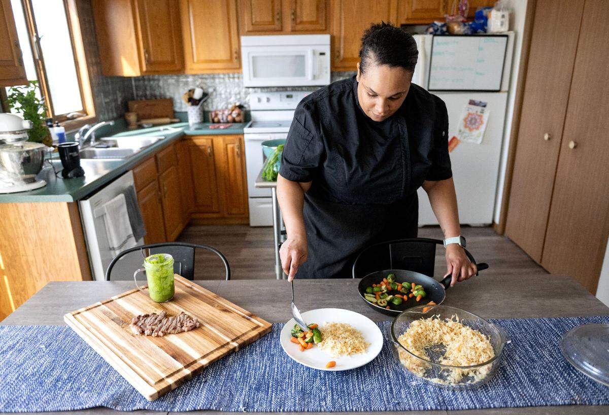 Chef Shavonne Hart plates a meal of steak, rice pilaf and vegetables on Thursday, June 26, 2025.