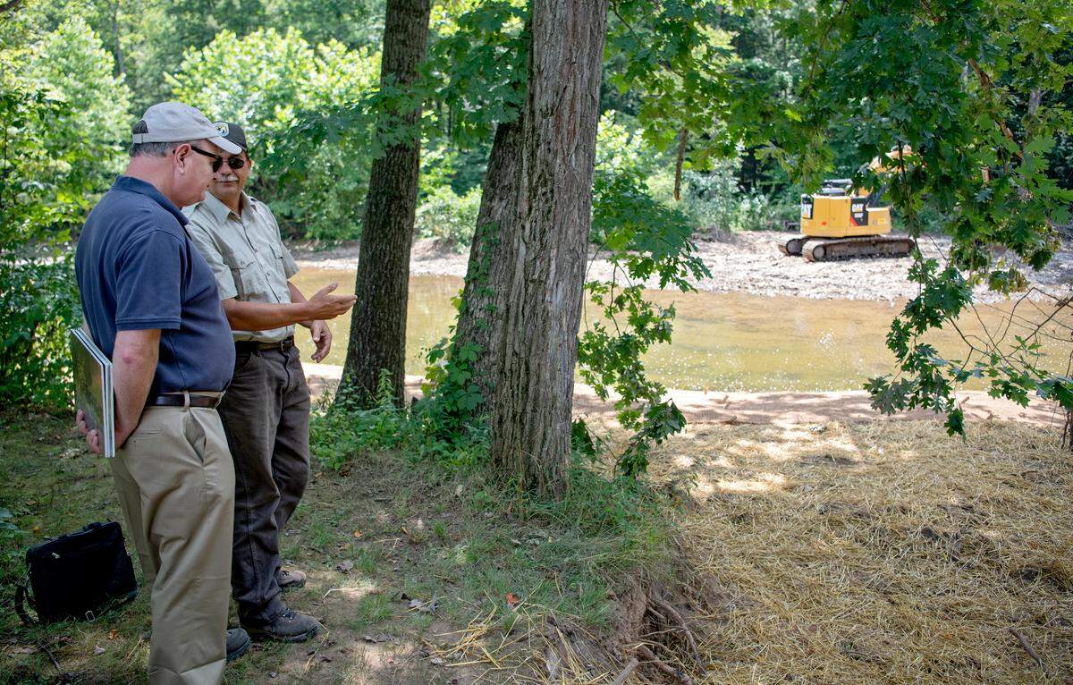 Jerry Regan and Mark Roberts chat about the new mud sill structure along the Bald Eagle Creek in Huston Township on Thursday, July 25, 2019.