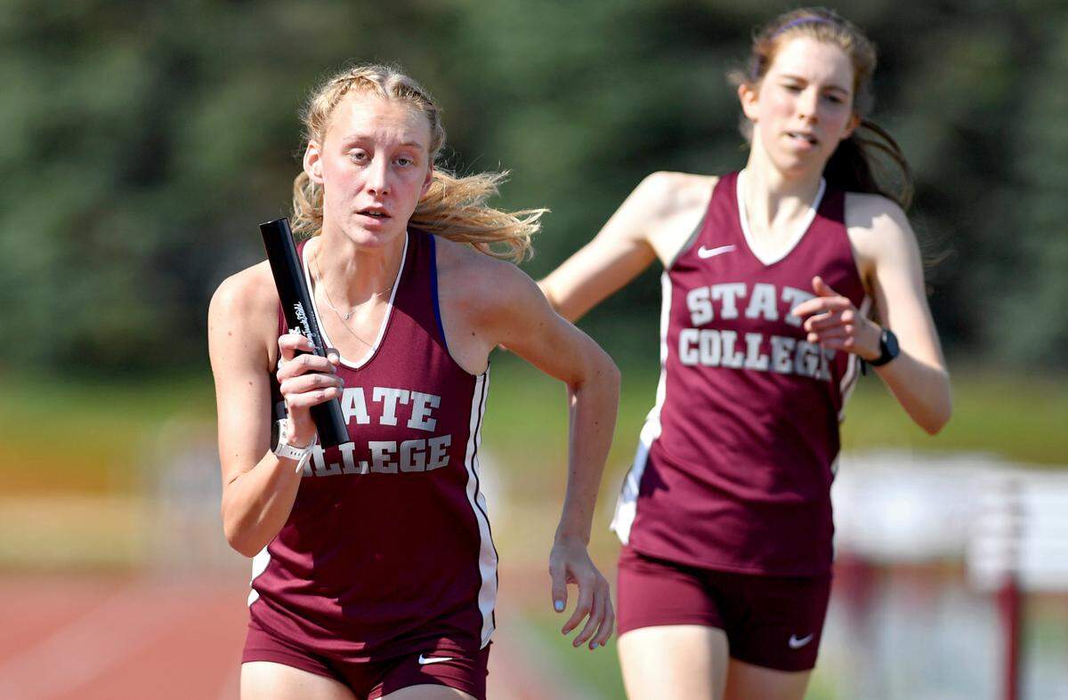 State College’s Karsyn Kane gets the hand off from Jordan Reed in the 4x800 meter relay at the District 6 3A track and field championships at Mansion Park on Thursday, May 20, 2021. The State College relay team came in first with a time of 9:35.69.