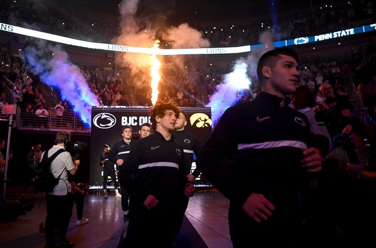 Penn State wrestlers run into the Bryce Jordan Center for the match against Iowa on Friday, Jan. 27, 2023.