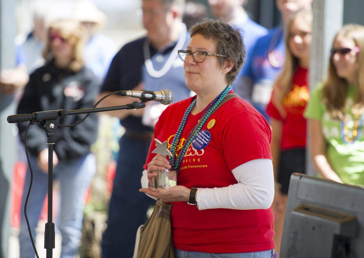 Centre County Out of the Darkness Walk chair Shanon Quick speaks before the annual walk after being presented the Founders Award on Sunday, April 24 , 2016 at Sidney Freidman Park in State College.