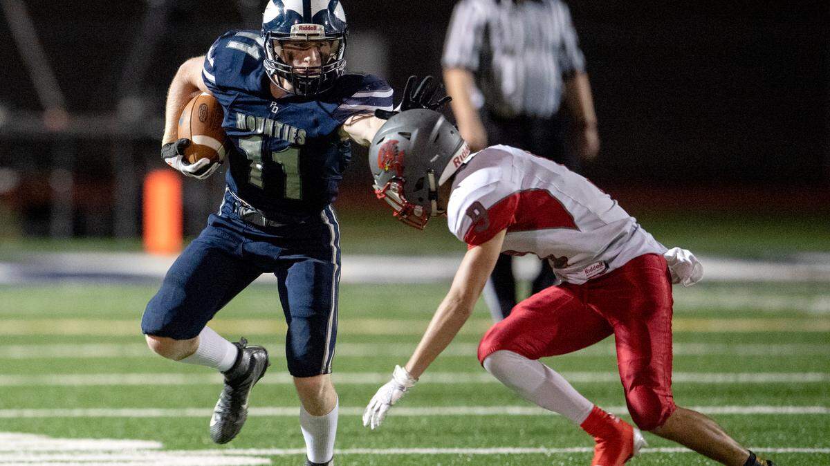 Philipsburg-Osceola’s Kaleb Stamm fights off Central’s Josh Biesinger as he runs down the field during the game on Friday, Sept. 25, 2020.