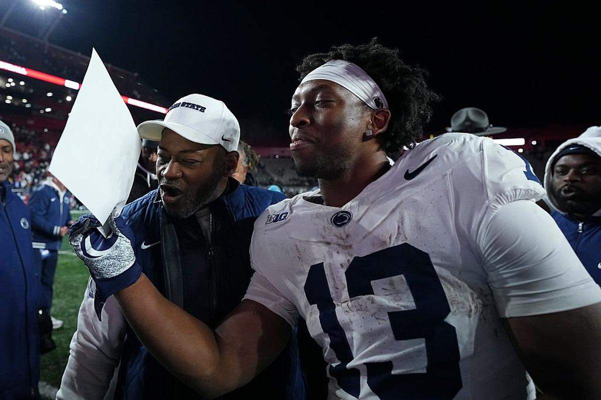 PISCATAWAY, NEW JERSEY - NOVEMBER 29: Interim head coach Terry Smith of the Penn State Nittany Lions celebrates with Kaytron Allen #13 after the game against the Rutgers Scarlet Knights at SHI Stadium on November 29, 2025 in Piscataway, New Jersey. The Penn State Nittany Lions defeated the Rutgers Scarlet Knights 40-36. (Photo by Mitchell Leff/Getty Images)