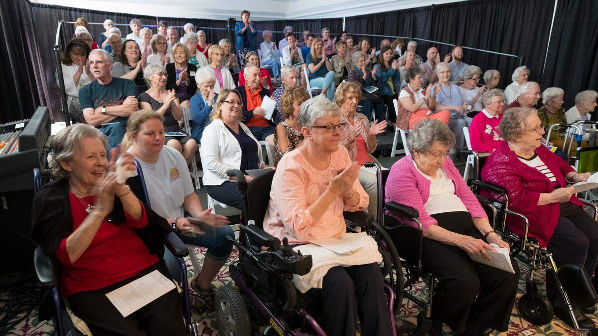 Juniper Village at Brookline residents attend a production of “Singing In The Rain” performed by fellow residents.