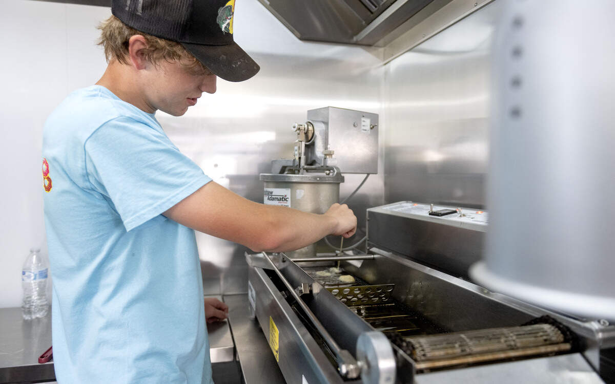 Gavin Guenot of Snowcap Sweets: By Mountaintop Concessions makes a batch of mini doughnuts on Thursday, July 9, 2026.