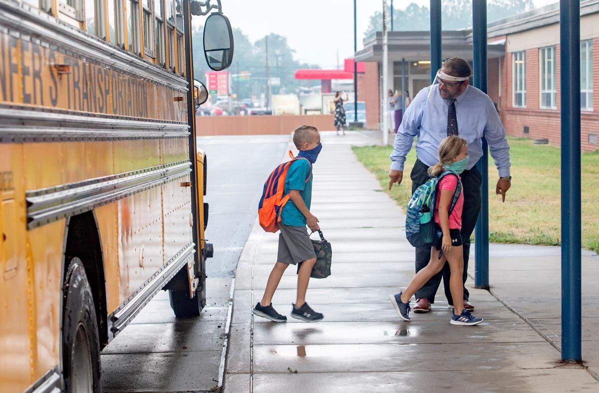 Wingate Elementary Principal James Orichosky wears a face shield as he excitedly welcomes students back to school on Tuesday, Aug. 25, 2020. Orichosky said teachers and staff are ready to have fun and reconnect with the students.