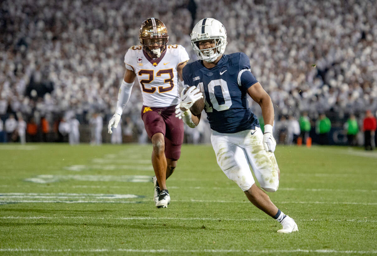 Penn State running back Nick Singleton runs for a touchdown ahead of Minnesota’s Jordan Howden during the game on Saturday, Oct. 22, 2022.