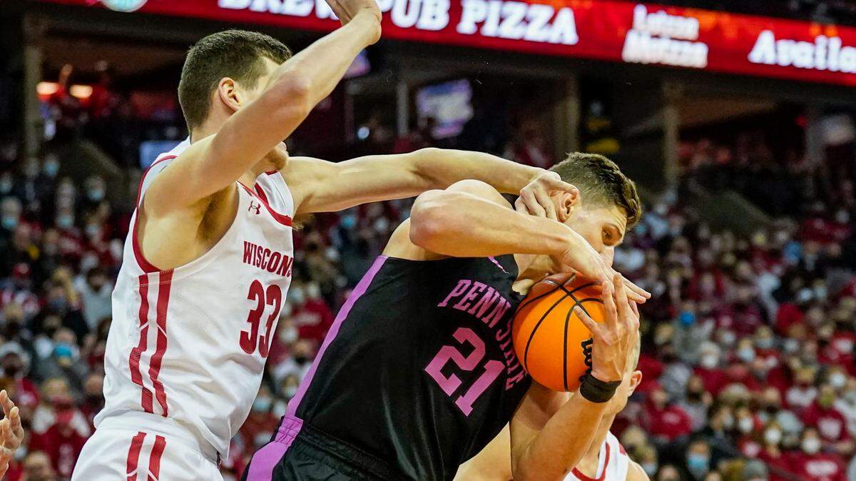 Penn State’s John Harrar (21) grabs an offensive rebound against Wisconsin’s Chris Vogt (33) during the first half of an NCAA college basketball game Saturday, Feb. 5, 2022, in Madison, Wis. (AP Photo/Andy Manis)