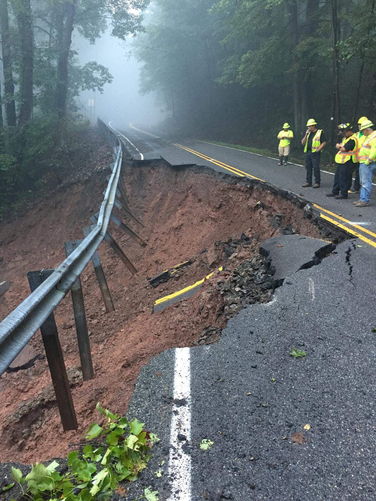 Pennsylvania Department of Transportation workers respond to a slide issue on state Route 3032/Beaver Road outside Julian, which was caused by excessive rain this summer.