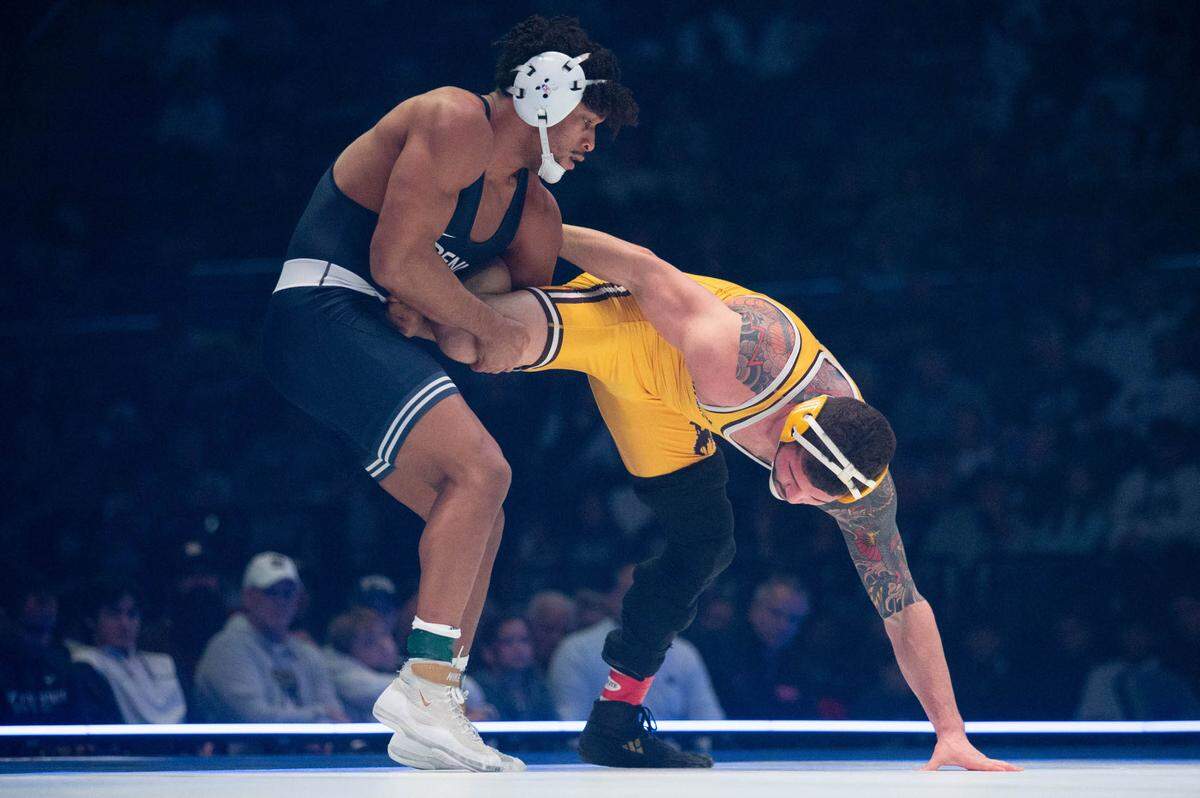At 184, Carter Starocci, left, wrestles Ethan Ducca, right, during the dual meet between Penn State and Wyoming on Sunday, Dec. 15, 2024.