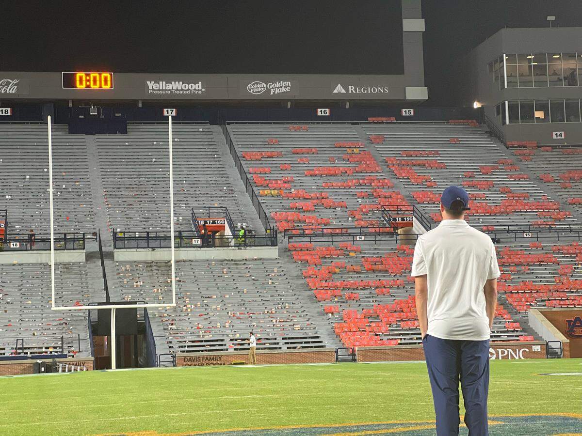 Penn State quarterback Sean Clifford takes a moment to himself on the Jordan-Hare Stadium field Saturday, Sept. 17, 2022, after a win against the Auburn Tigers.
