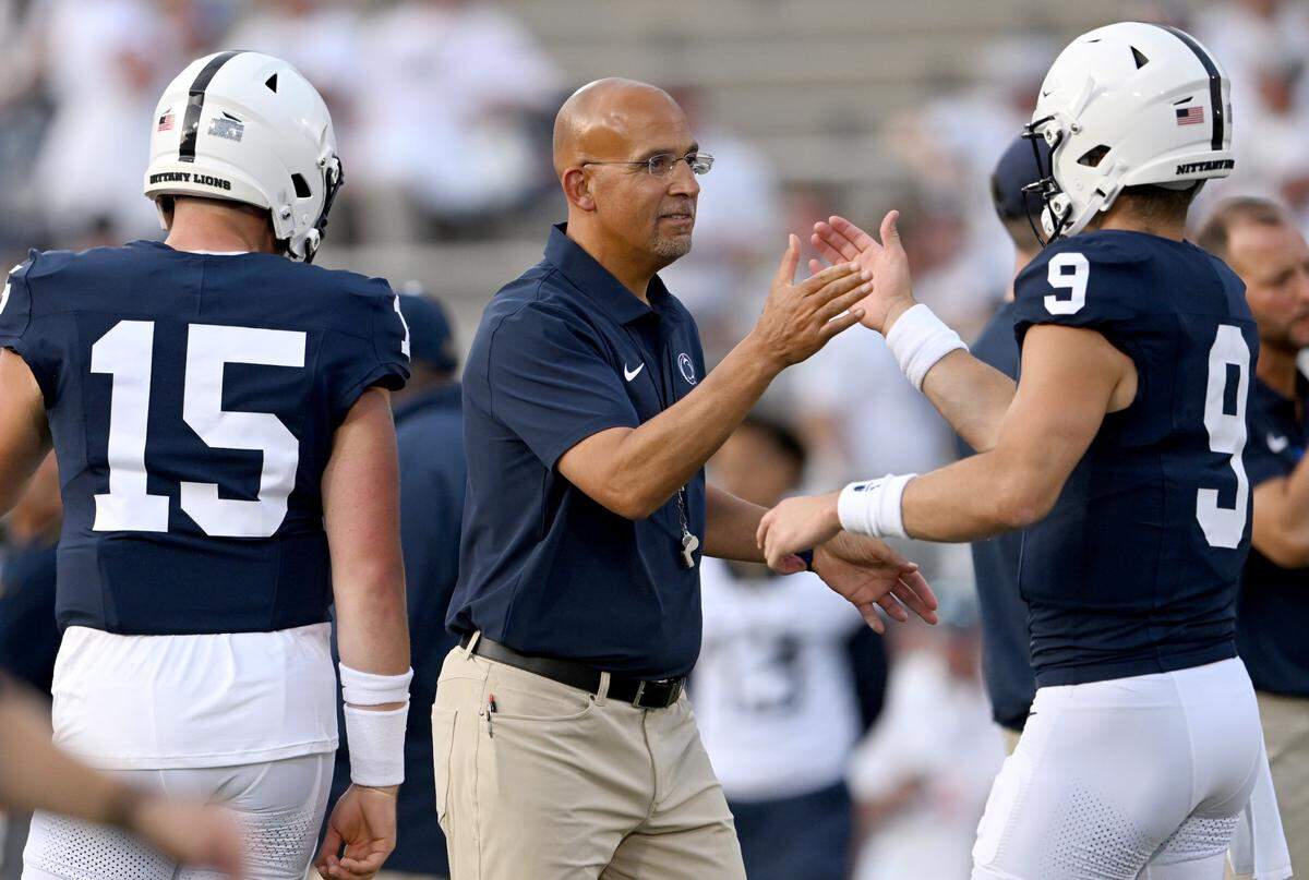 Penn State football coach James Franklin high fives quarterback Beau Pribula during warmups for the game against West Virginia on Saturday, Sept. 2, 2023.