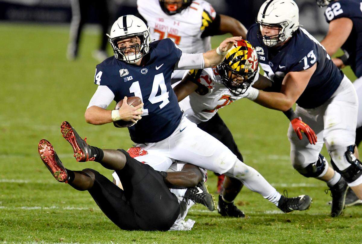 Penn State quarterback Sean Clifford gets sacked by Maryland defenders in the third quarter of the game on Saturday, Nov. 7, 2020 at Beaver Stadium.