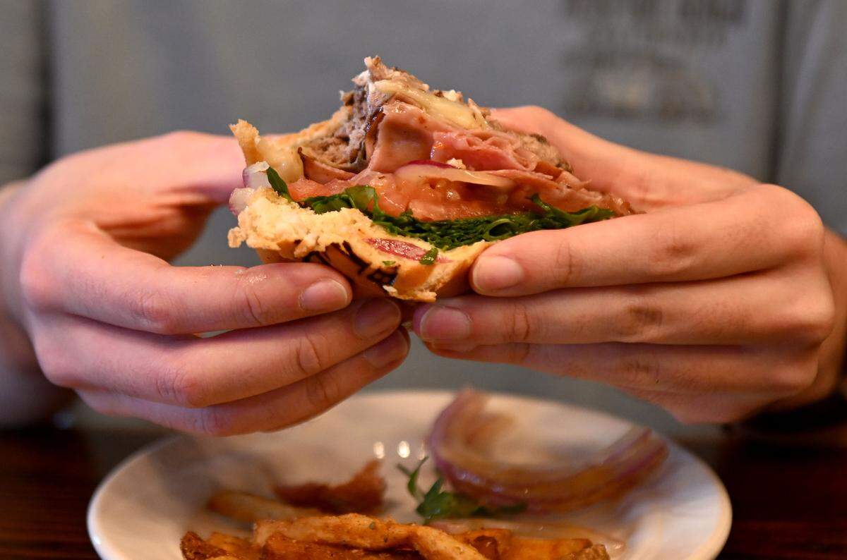 Centre Daily Times reporters try Coach Campbell’s Roman Burger at The Field. The new burger features salami, mortadella, white cheddar, arugula, tomato, onion, mayo and Italian dressing on a brioche roll.